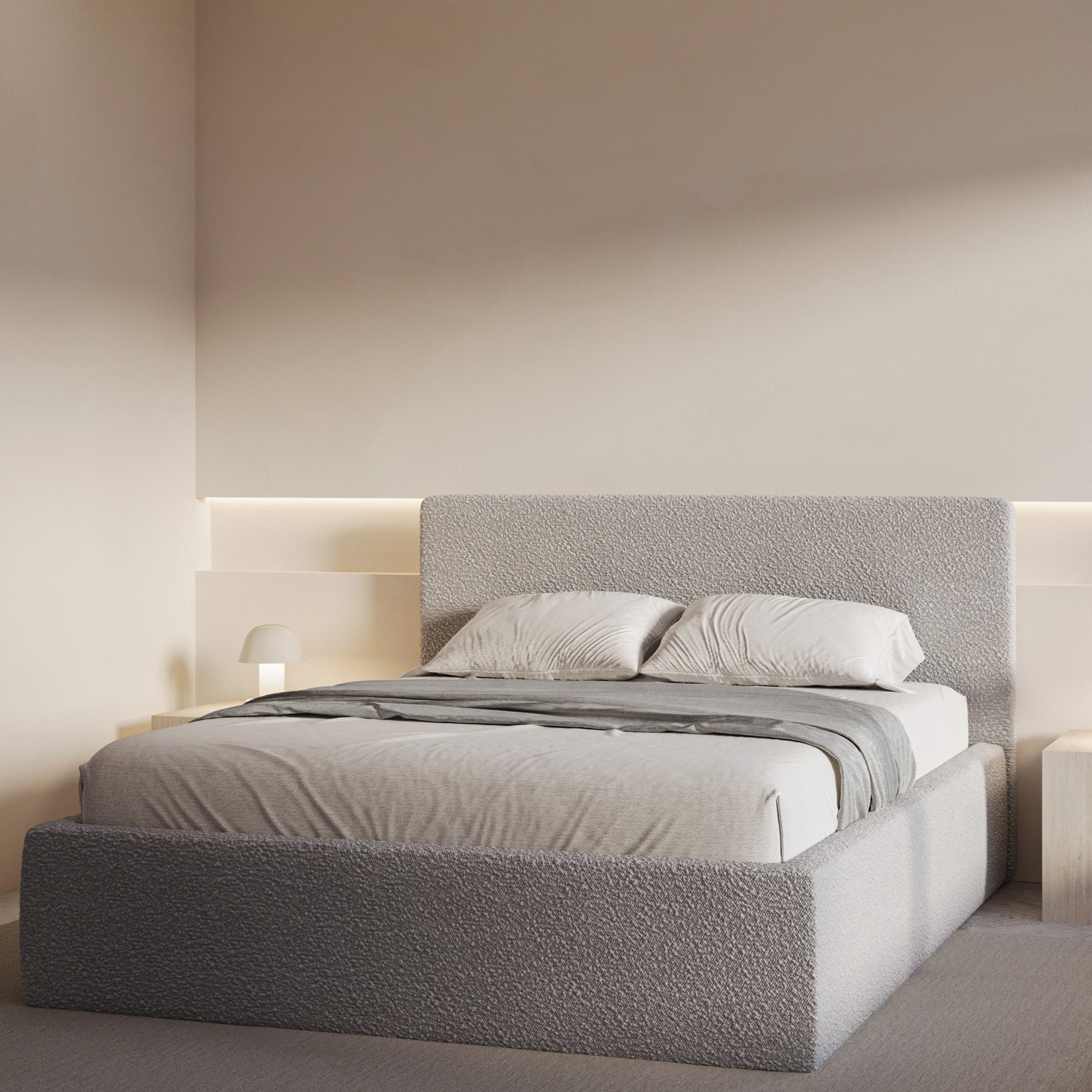 Modern bedroom with a gray upholstered bed and matching headboard.